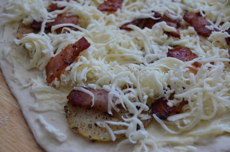 bacon and potato pizza with caramelized onion and roasted garlic cream sauce